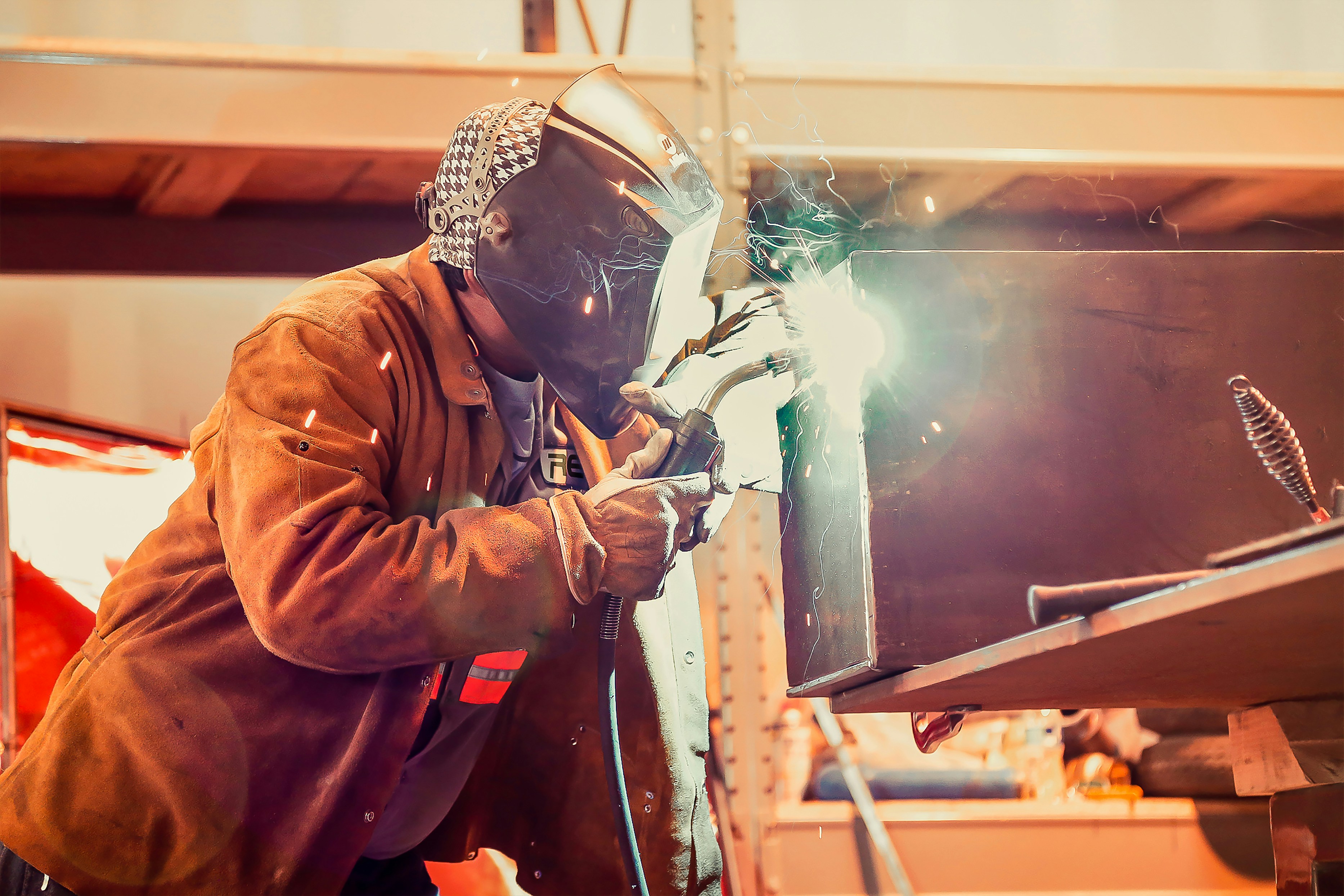 Man weding on steel beam at TratFab in Star, Idaho.