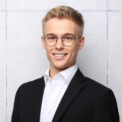 a man with a goatee smiles at the camera