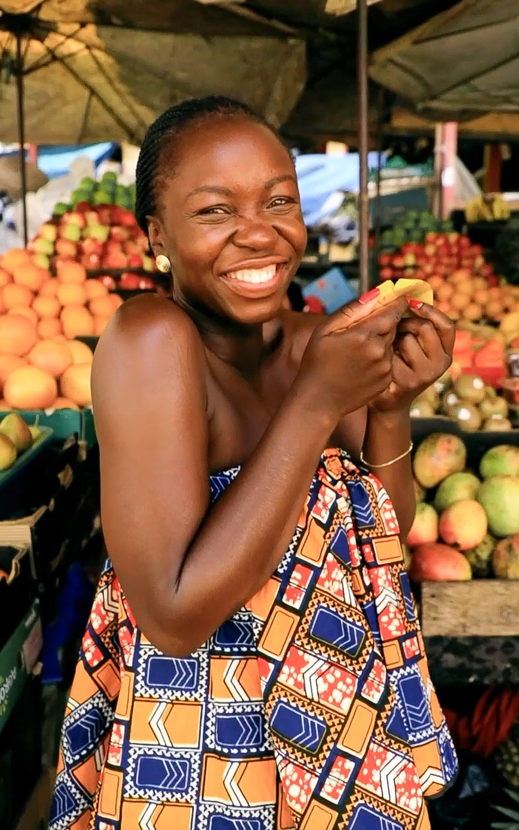 Mary Consolata Namagambe enjoying the 'fruits' of local market shopping in Uganda, Africa