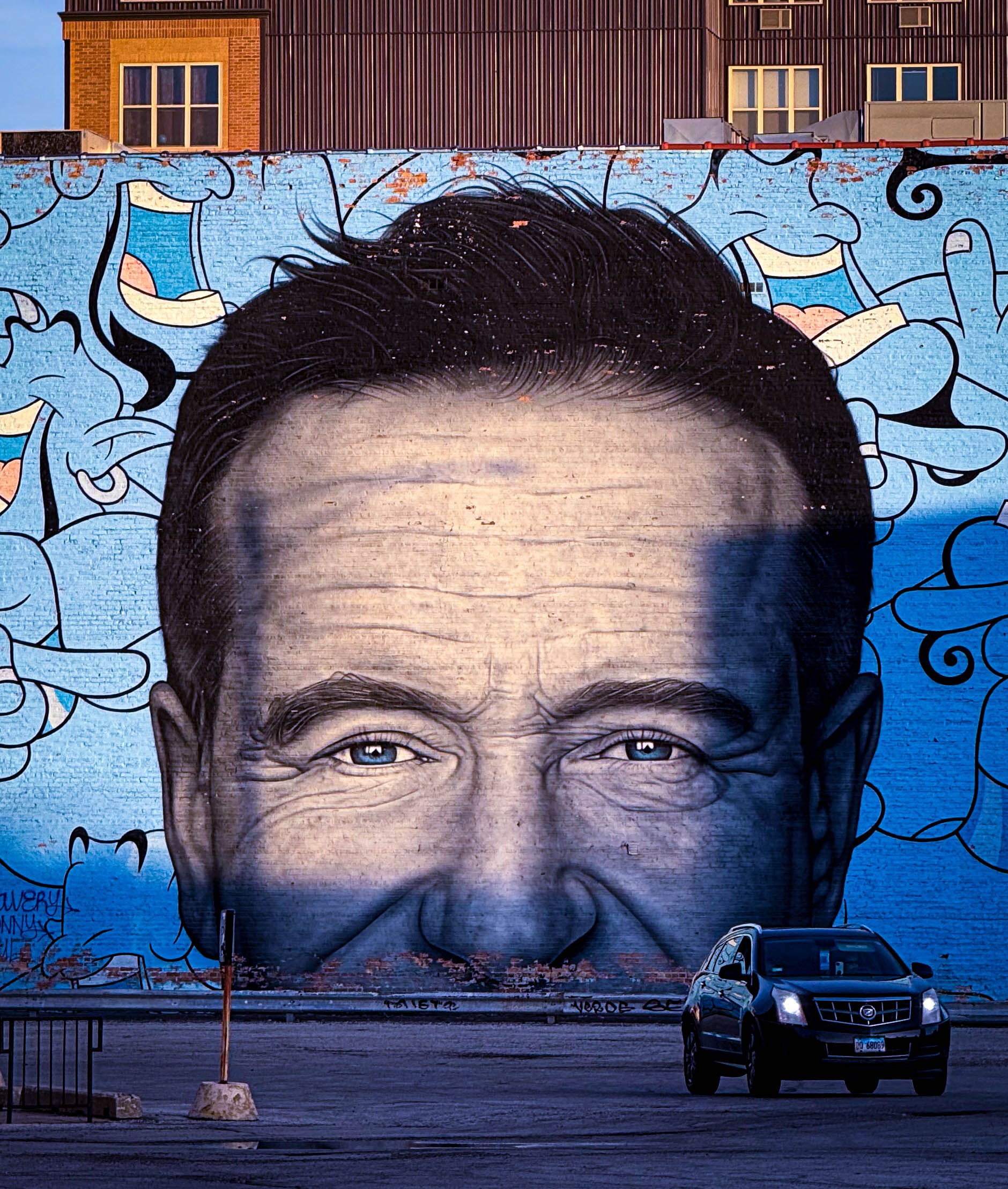the mural of robin williams on the side of a logan square building