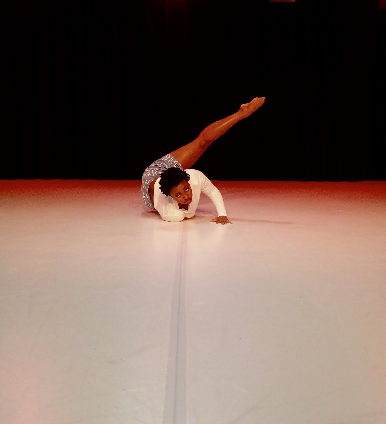 kids lying on a glass land and smiling