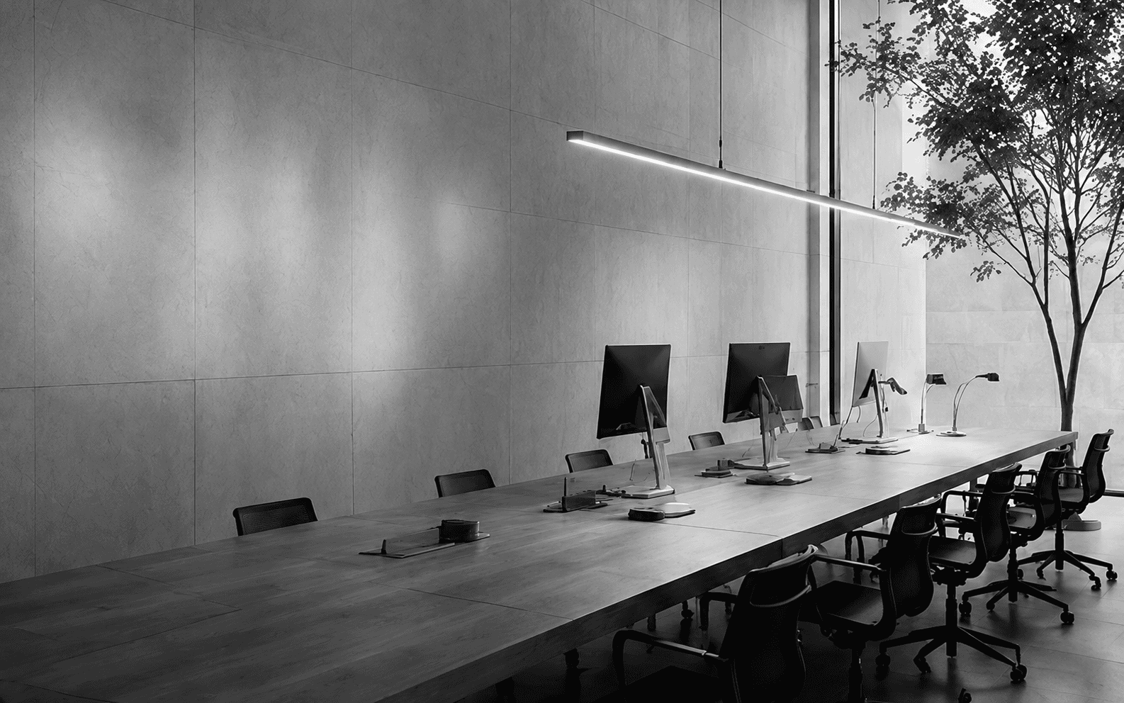 Minimal boardroom with long table and floor-to-ceiling windows