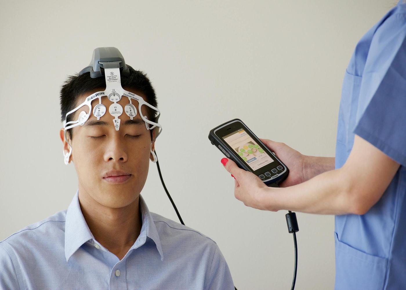 Sleep spindles - Doctor tracking a man's brain activity