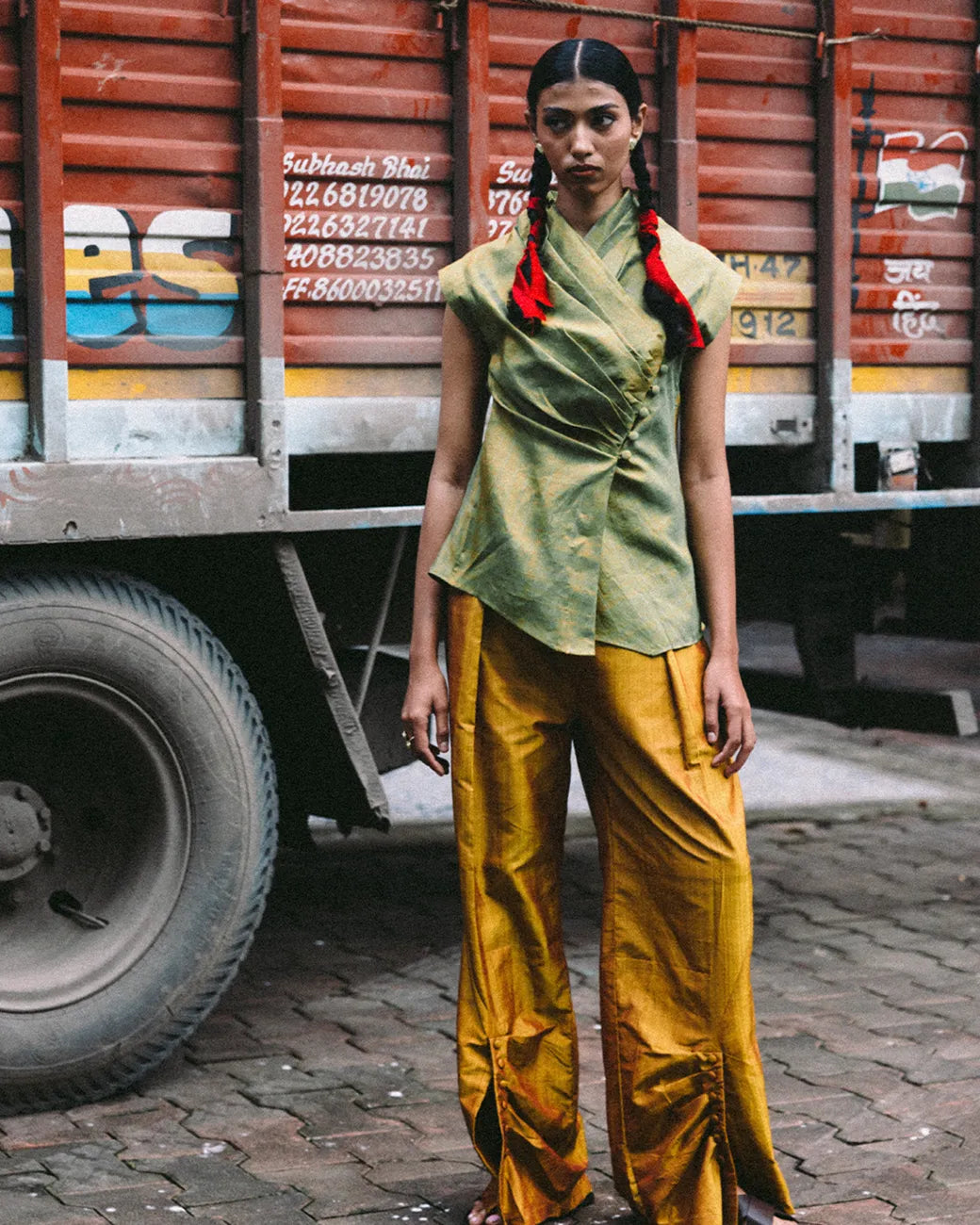 Antrikha asymmetrical silk top with folded neckline and side buttoned flap drape