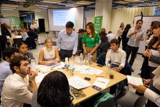 Close-up of a dark green leaf showing its textured surface and central vein against a muted background.