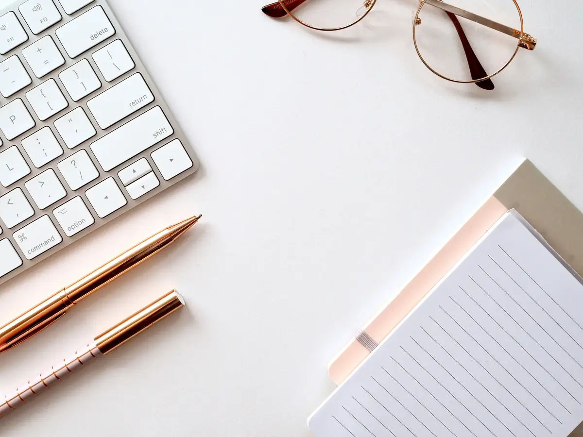 White workspace with keyboard and notebook