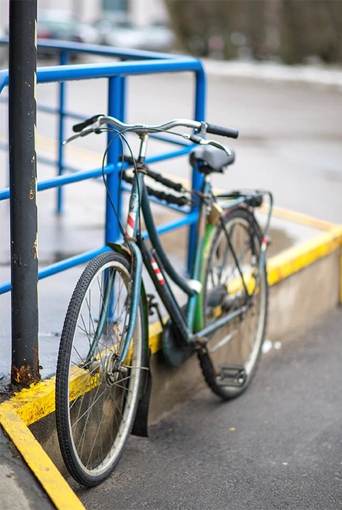Bike resting against railing, used to highlight bicycle injury lawyer services in Stockton