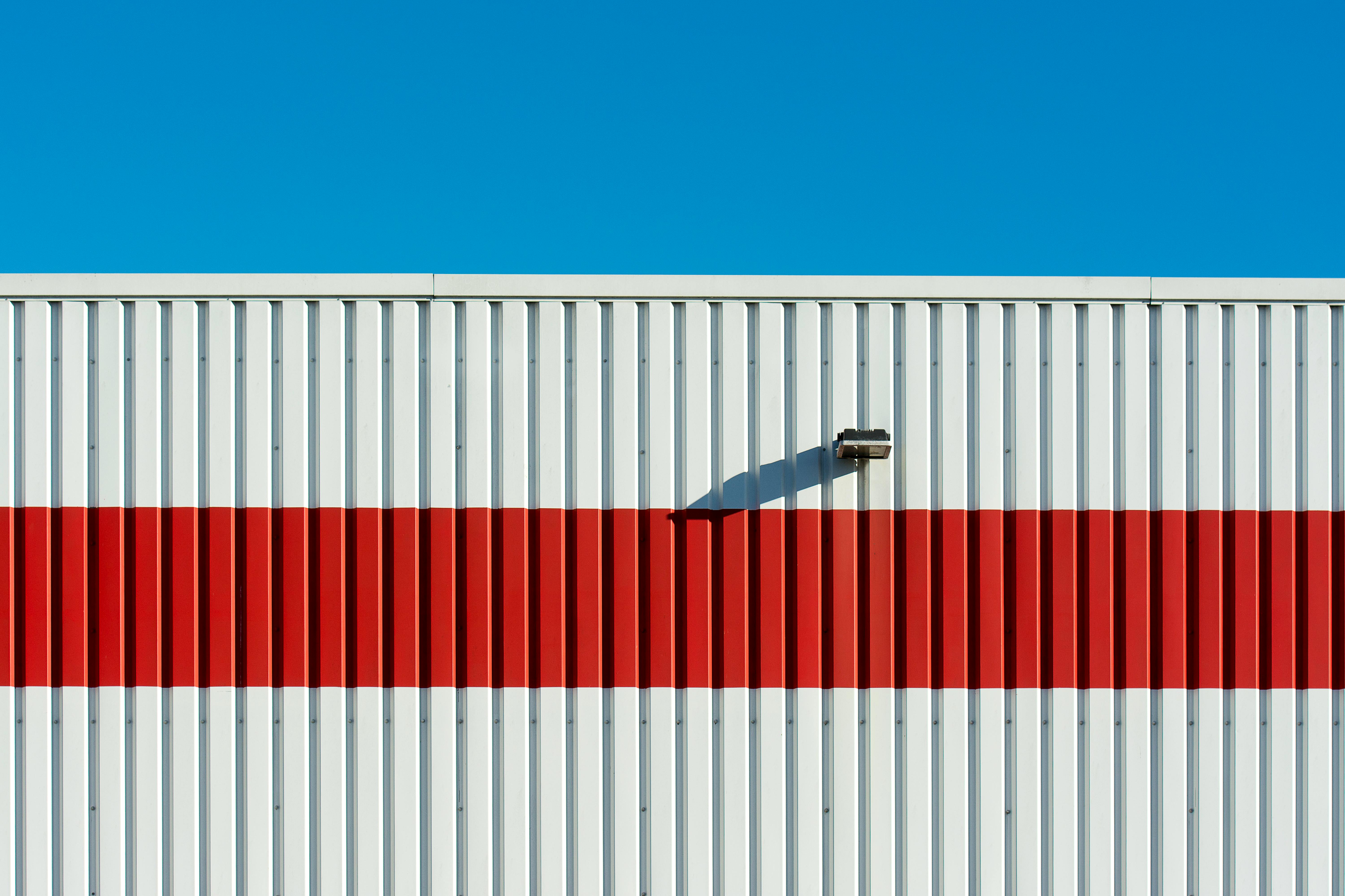 Striped corrugated metal wall with mounted light