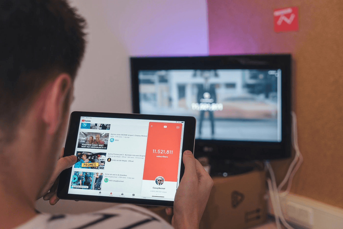 Person viewing YouTube on a tablet - How to Create a Faceless YouTube Channel