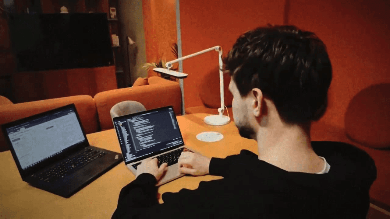 Close-up of hands holding a petri dish with visible samples, in a lab setting with soft golden lighting and scientific tools in the background.