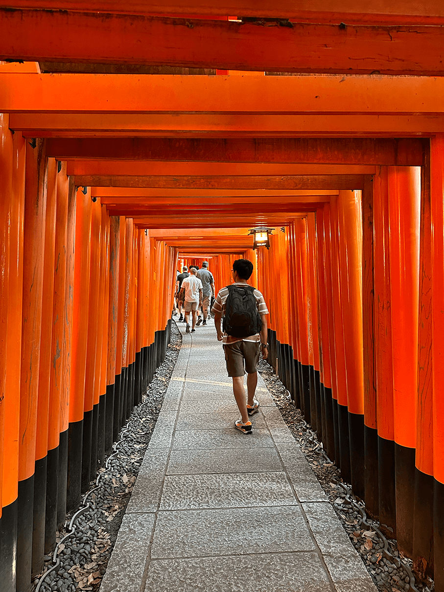 a group of people walking on a sidewalk