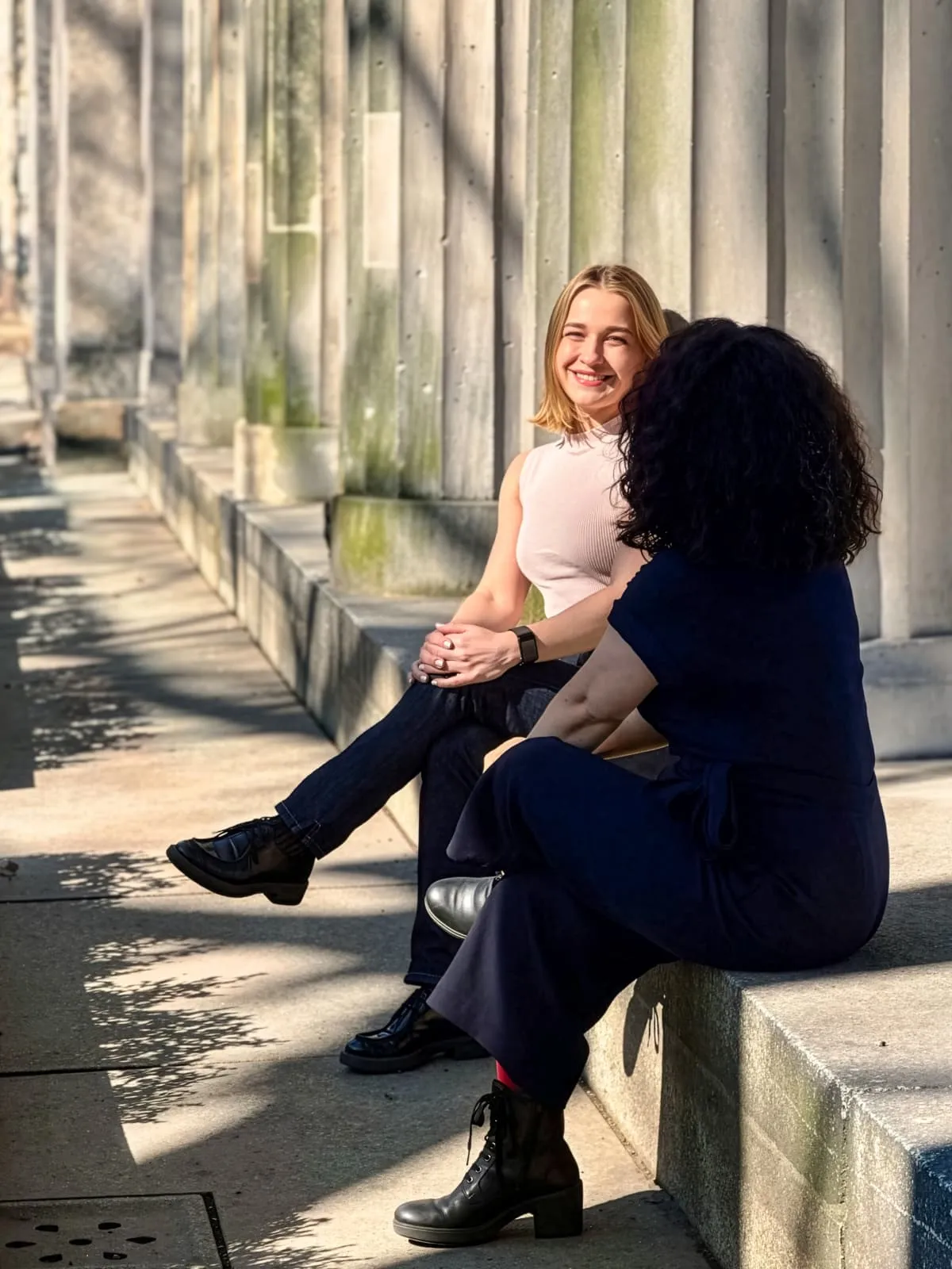Career coach Jenia in a relaxed conversation with a client outdoors in Berlin