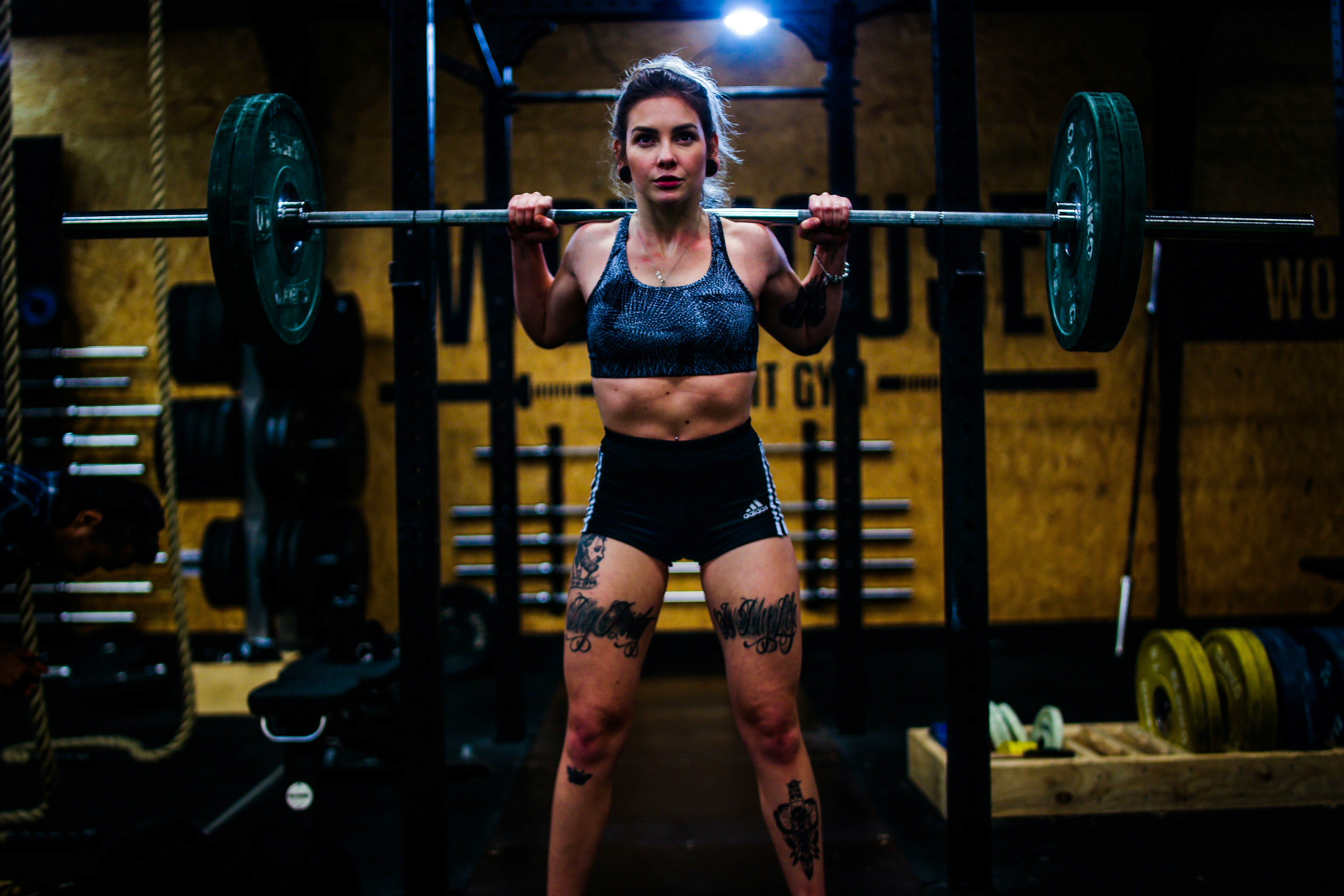 woman standing and carrying barbell