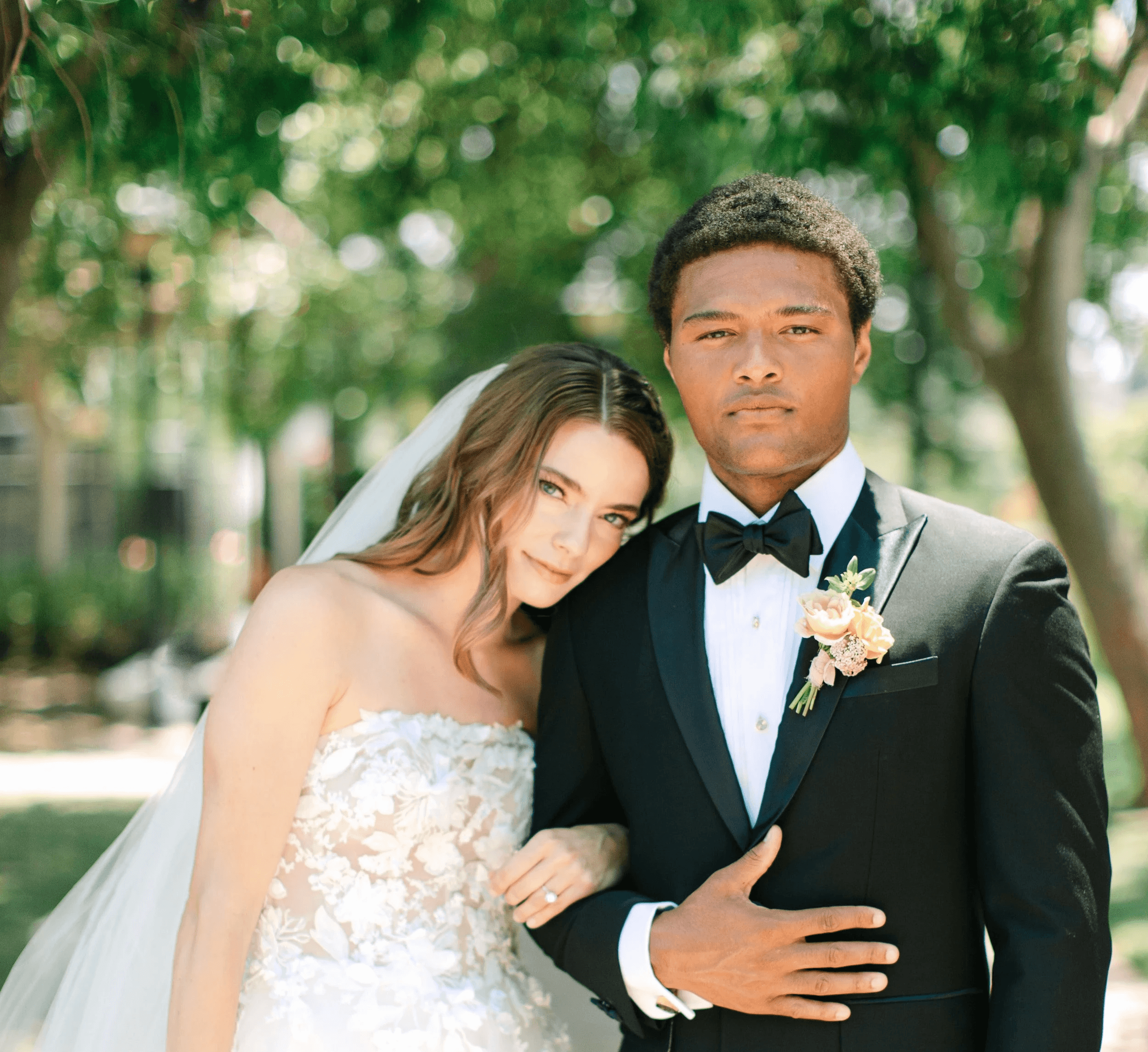 Image of a bride and groom smiling at camera