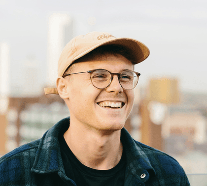 Warm cinematic side-profile portrait of a young man with glowing circular backlight.