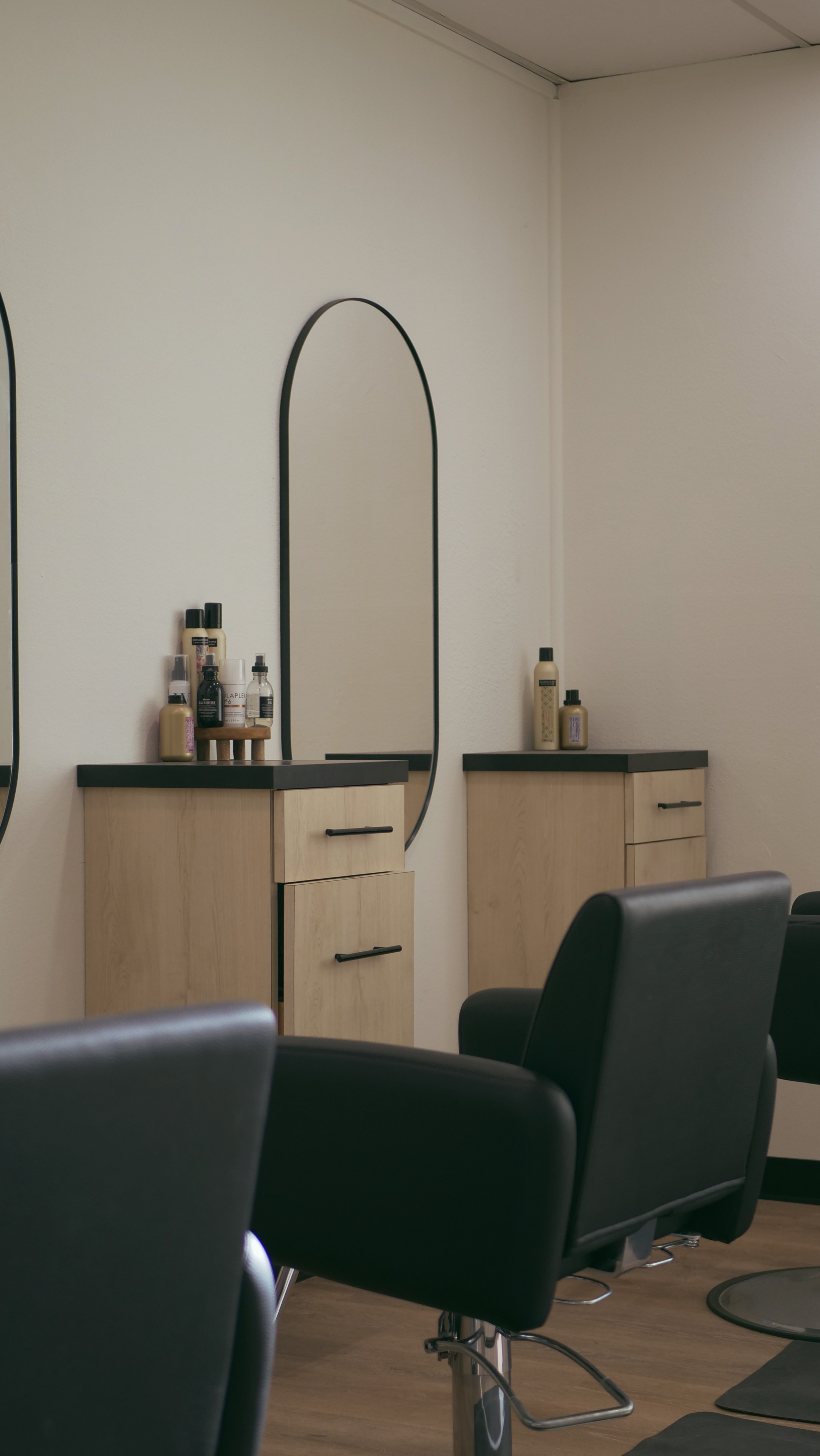 A luxurious indoor pool area with a panoramic view of a city at sunset. Comfortable lounge beds with soft fabrics surround the pool, while warm ambient lighting enhances the sophisticated atmosphere. The space combines modern elegance with a tranquil vibe.