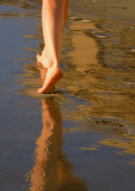 A woman's foot in the water.