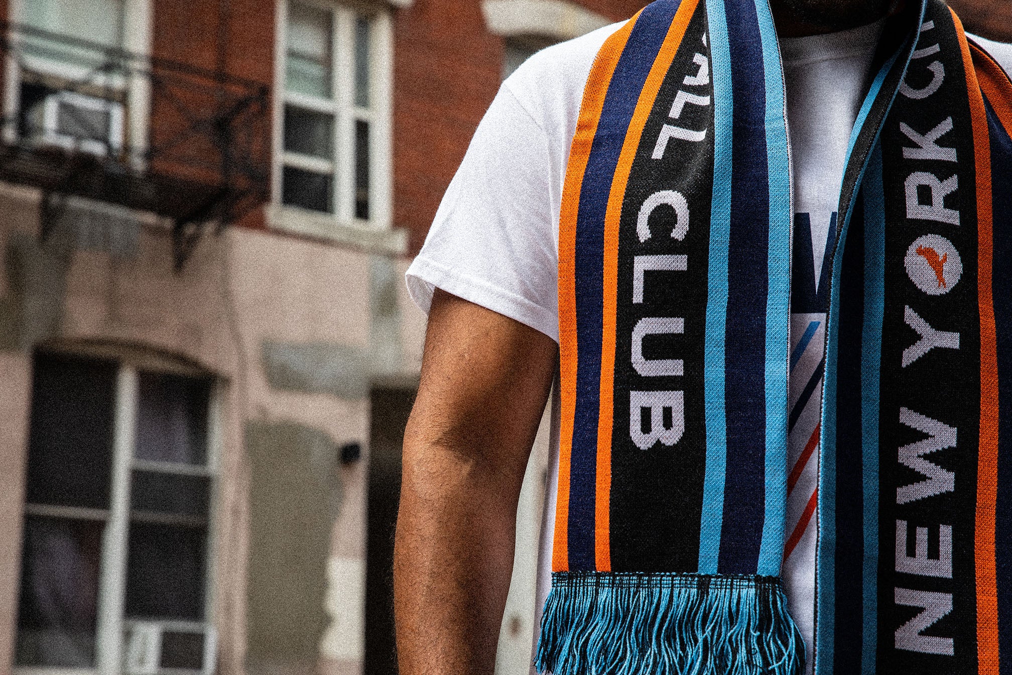 Model wearing an NYCFC scarf and Staple x NYCFC apparel during the Extra Butter collaboration shoot in New York.