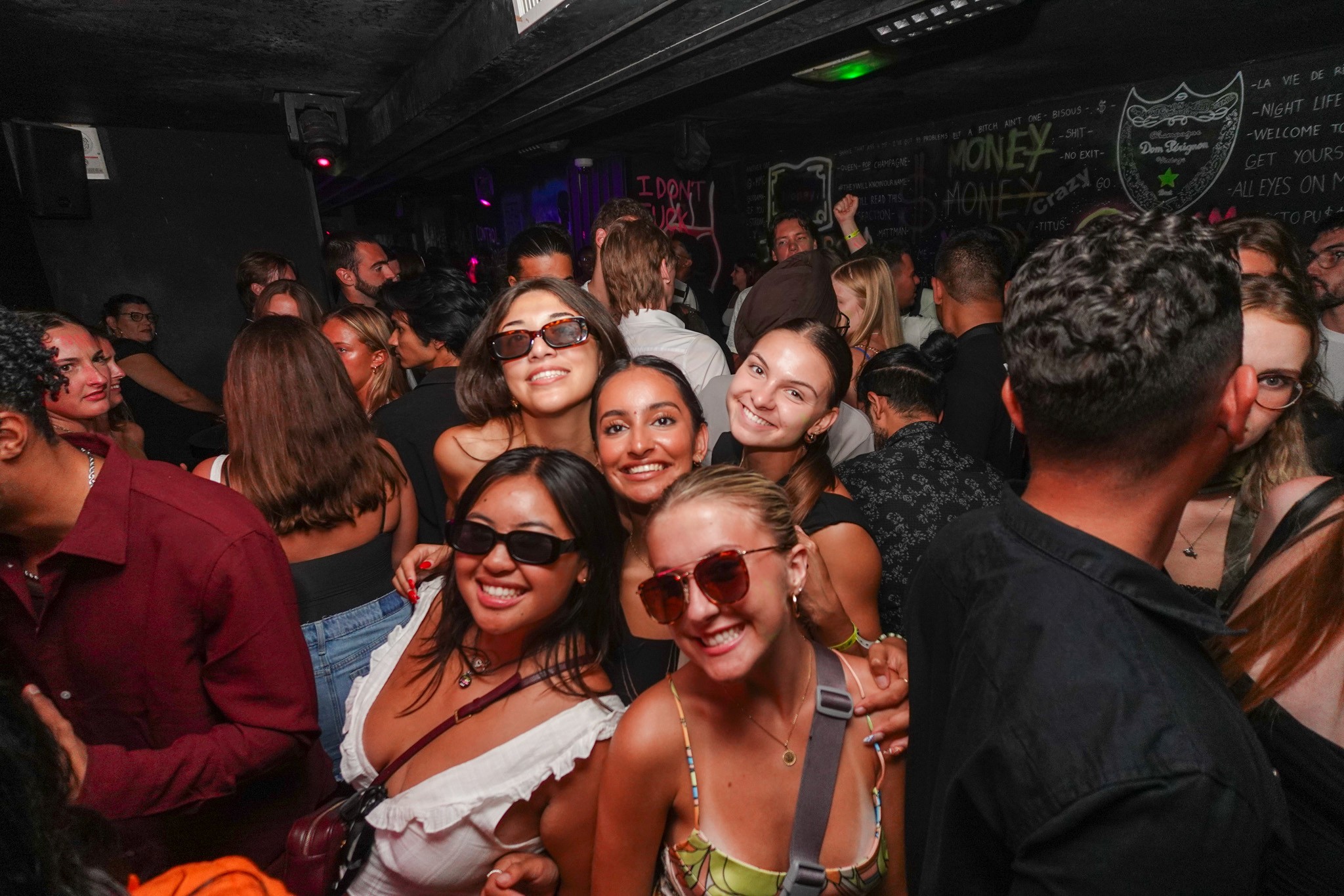 Young adults enjoying nightlife in Nice, moving between bars, dancing, and socializing in lively streets after dark.