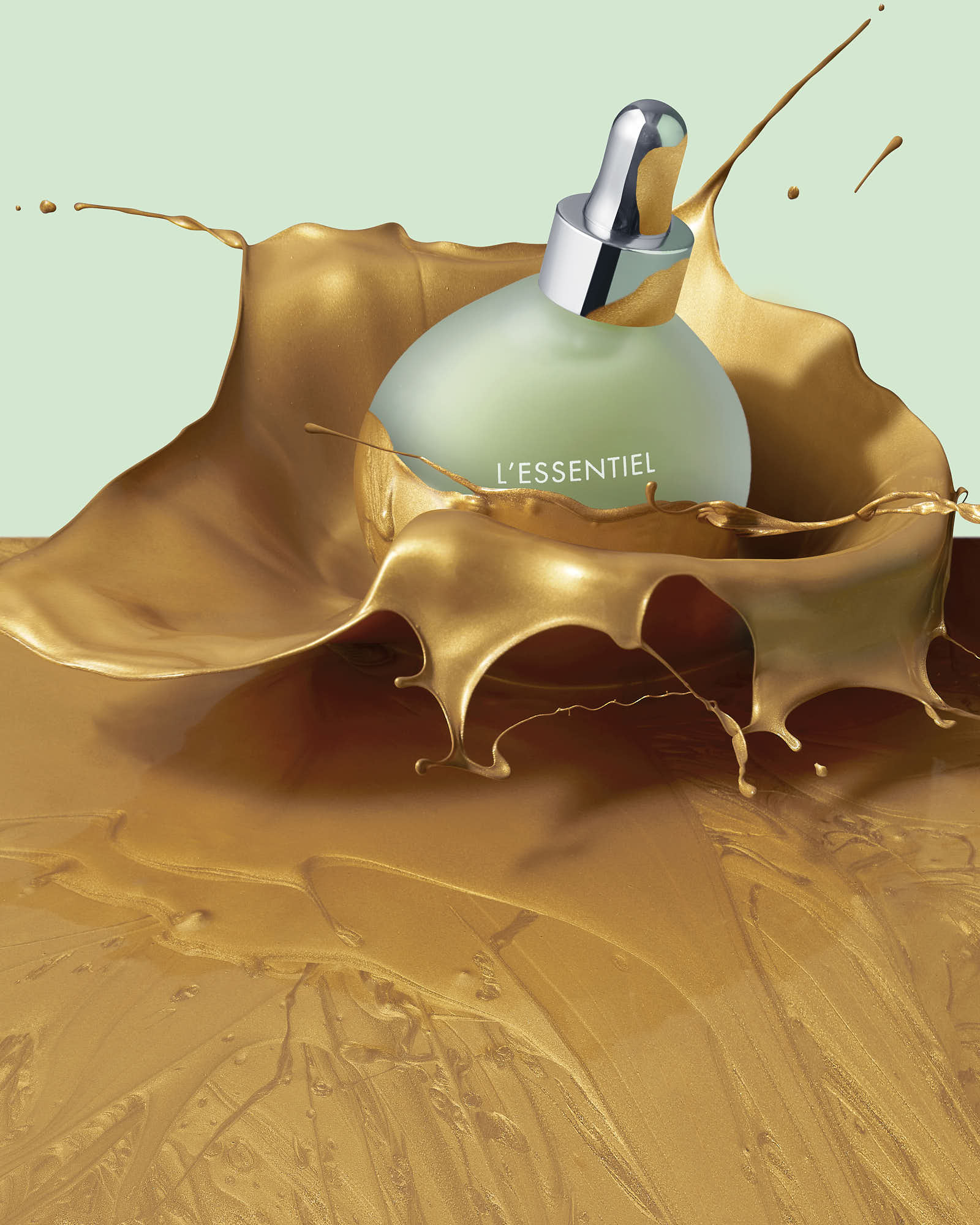 A delicate perfume bottle rests on a beautifully shaped, textured leaf against a soft, pale background.