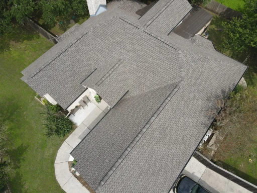 Completed: Austin Shingle Roof Replacement Around a Stone Chimney.