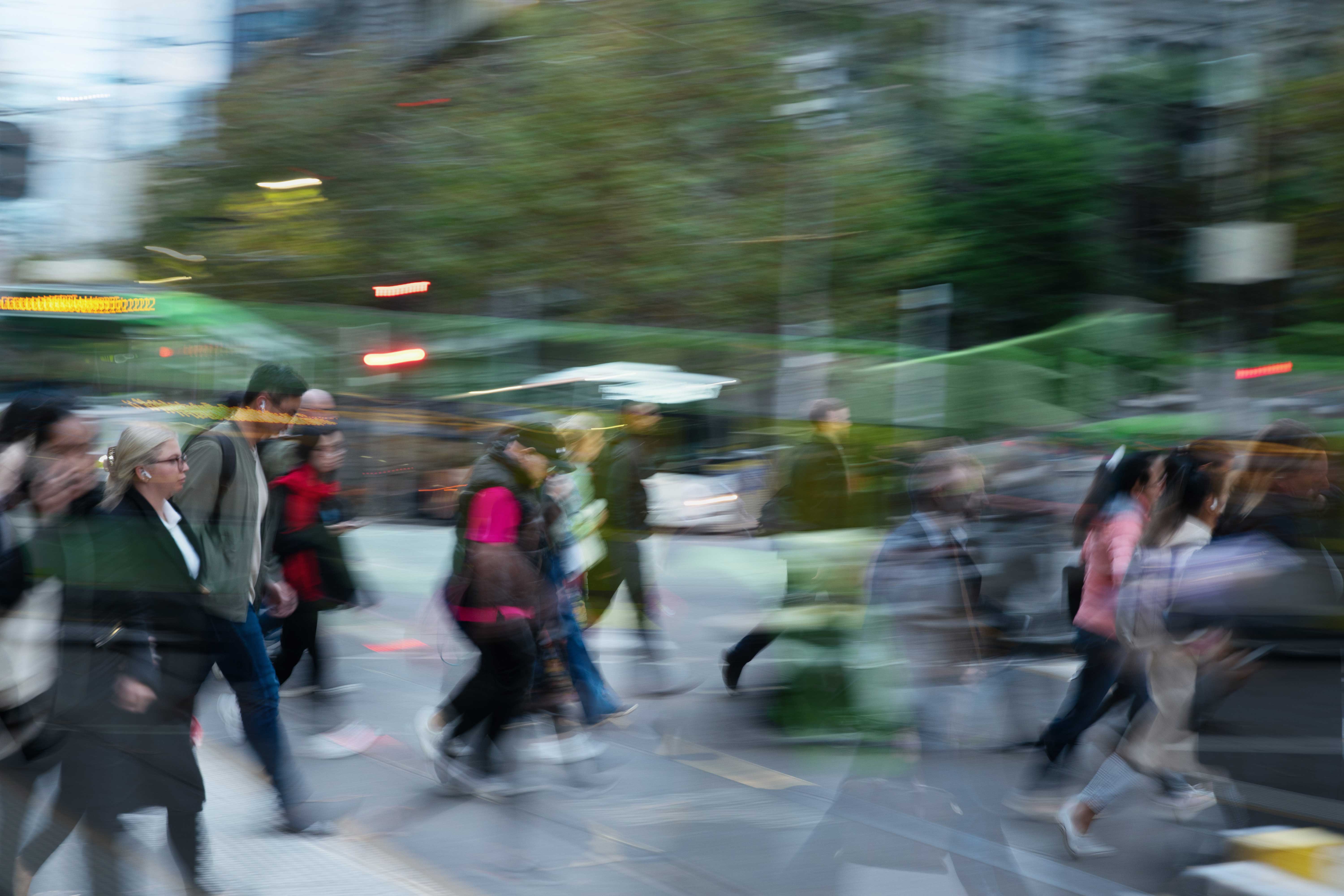 People walking through the city at a crossing