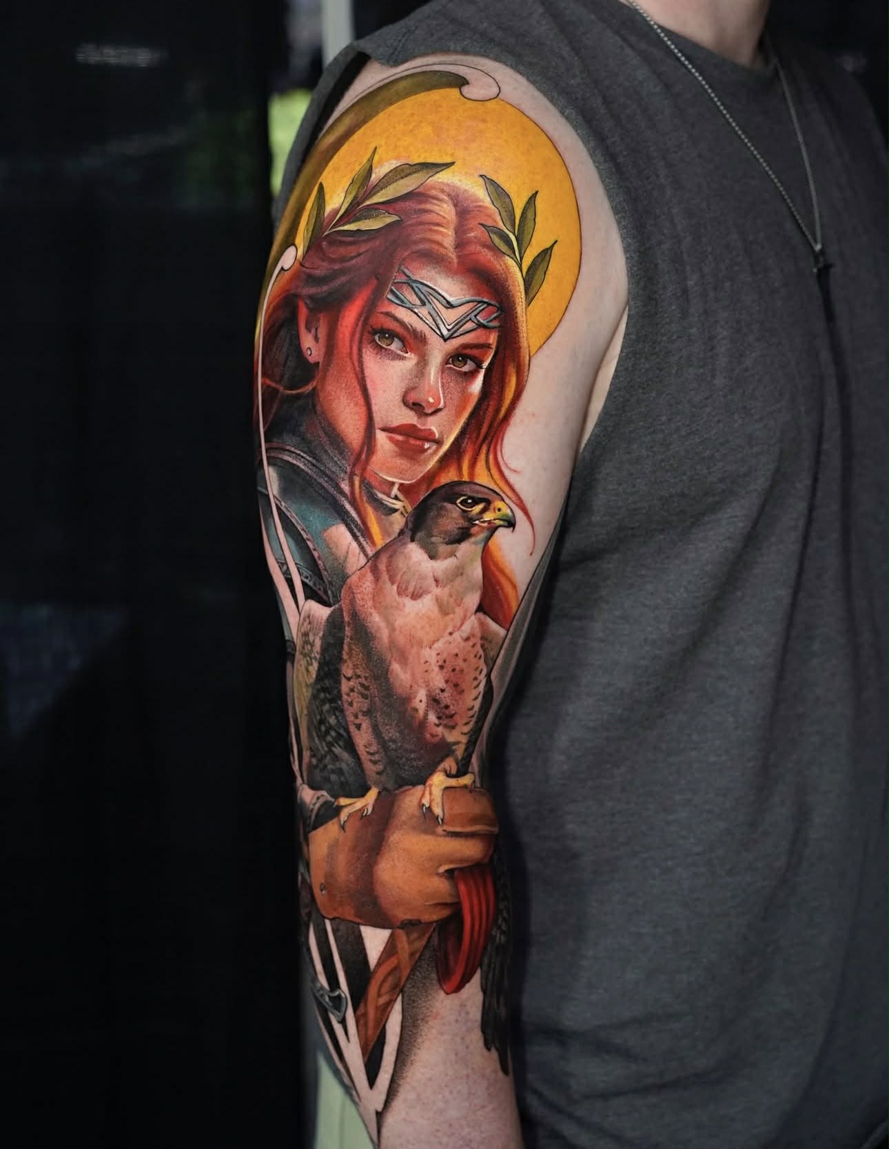 Full-arm tattoo combining hands, snakes, and geometric symbols.