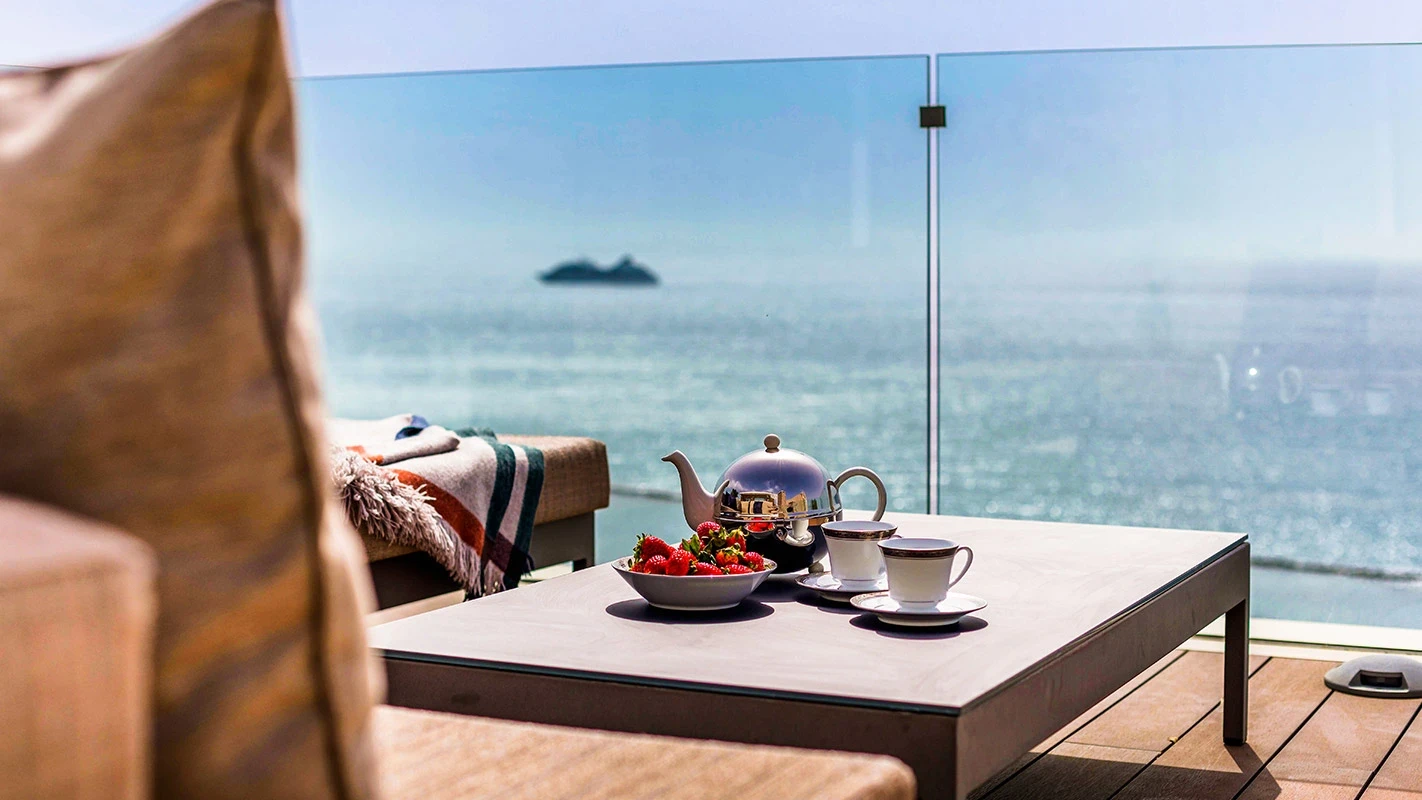 Seafront Residence Limassol sea-view balcony vignette with breakfast tray styling and glass balustrade