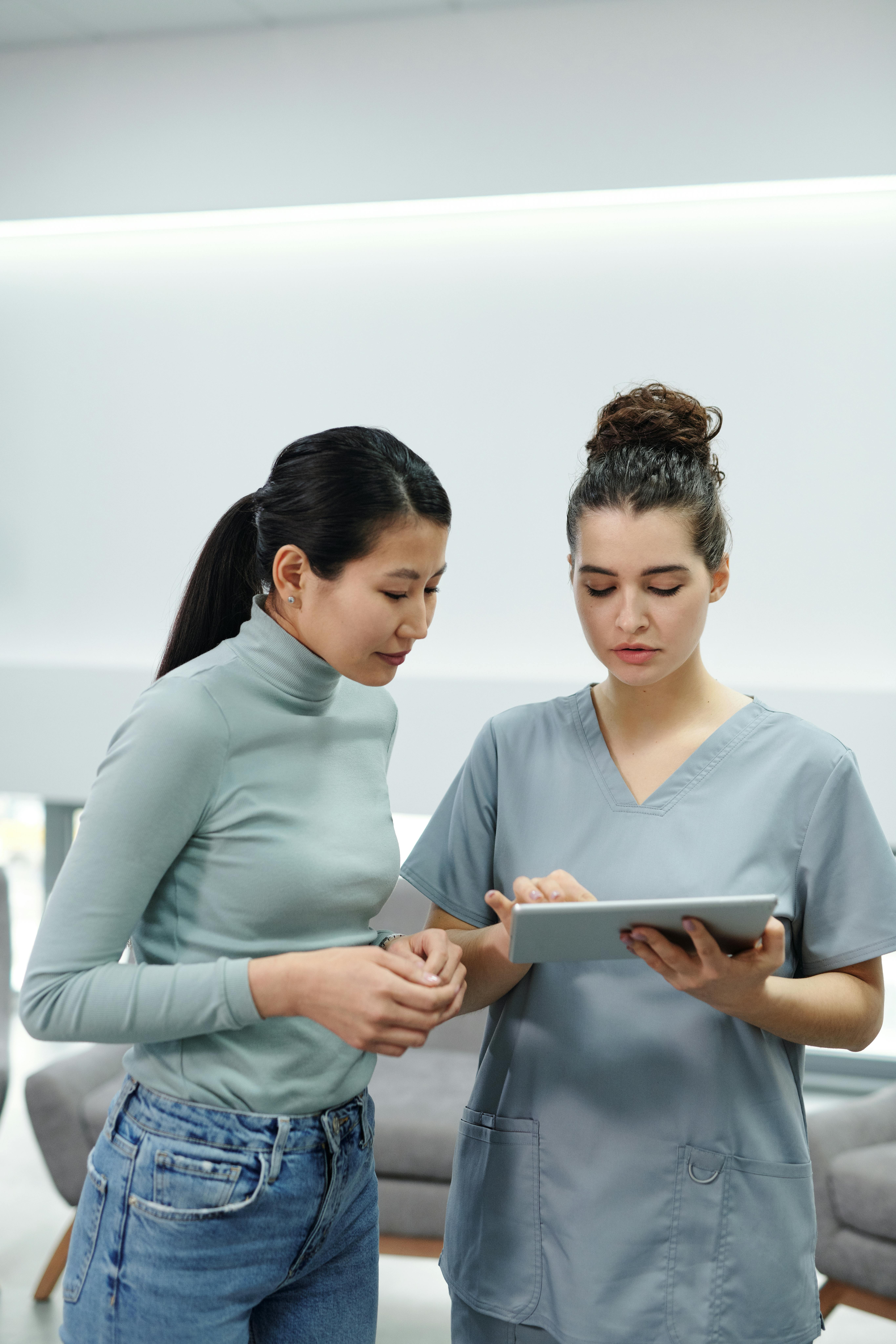 dental hygienist showing patient something on ipad