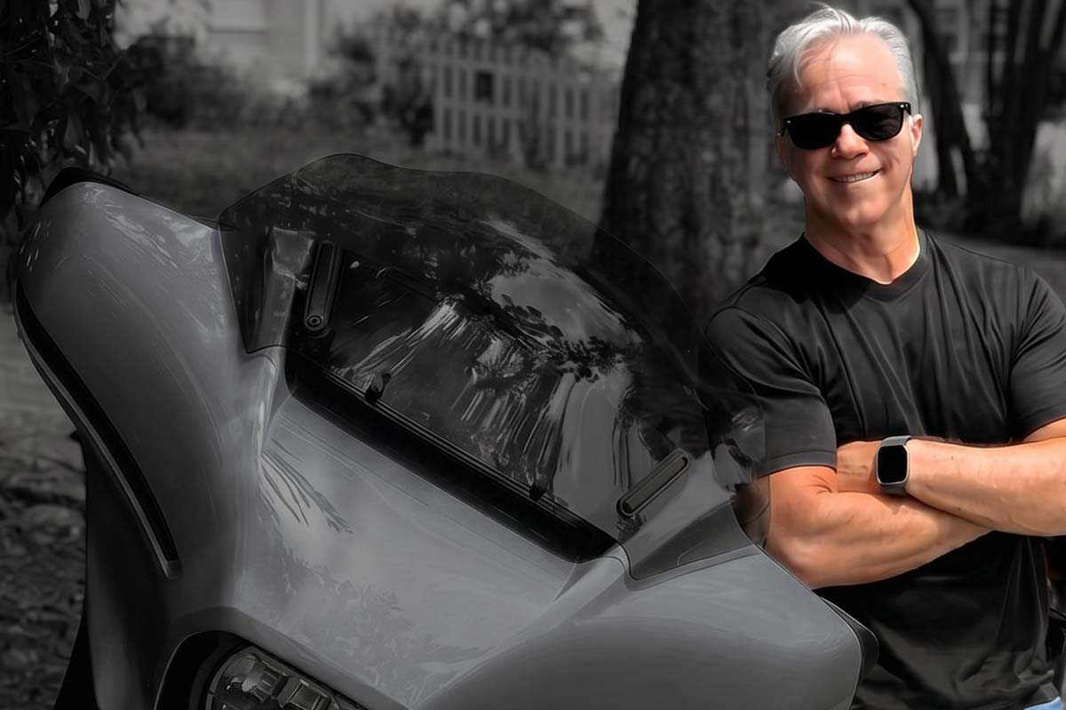 Scott Smith standing with his Harley