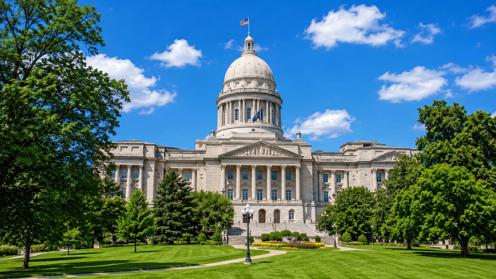 Kentucky State Capitol in Frankfort surrounded by trees and lawn