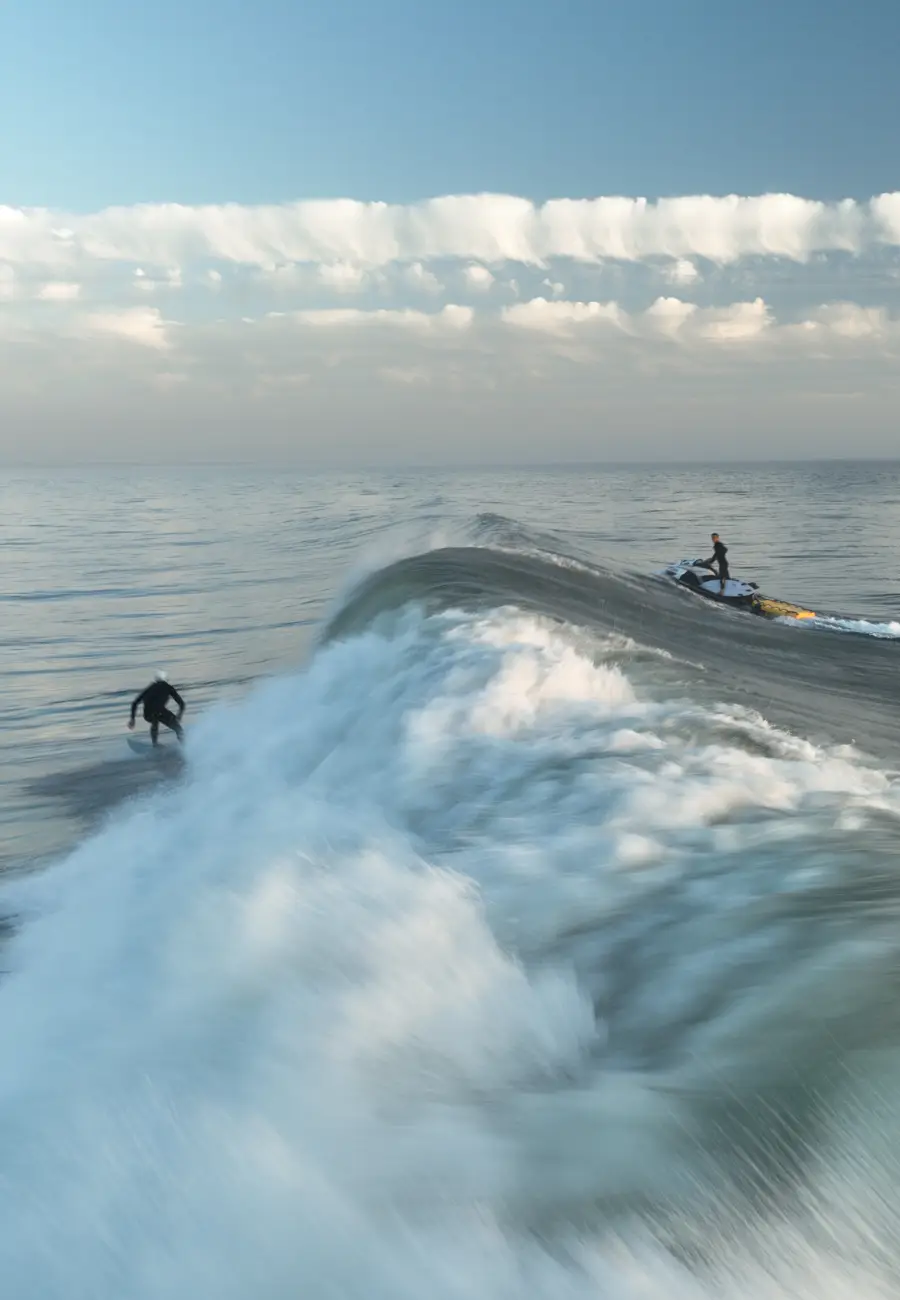 man surfing on sea waves during daytime