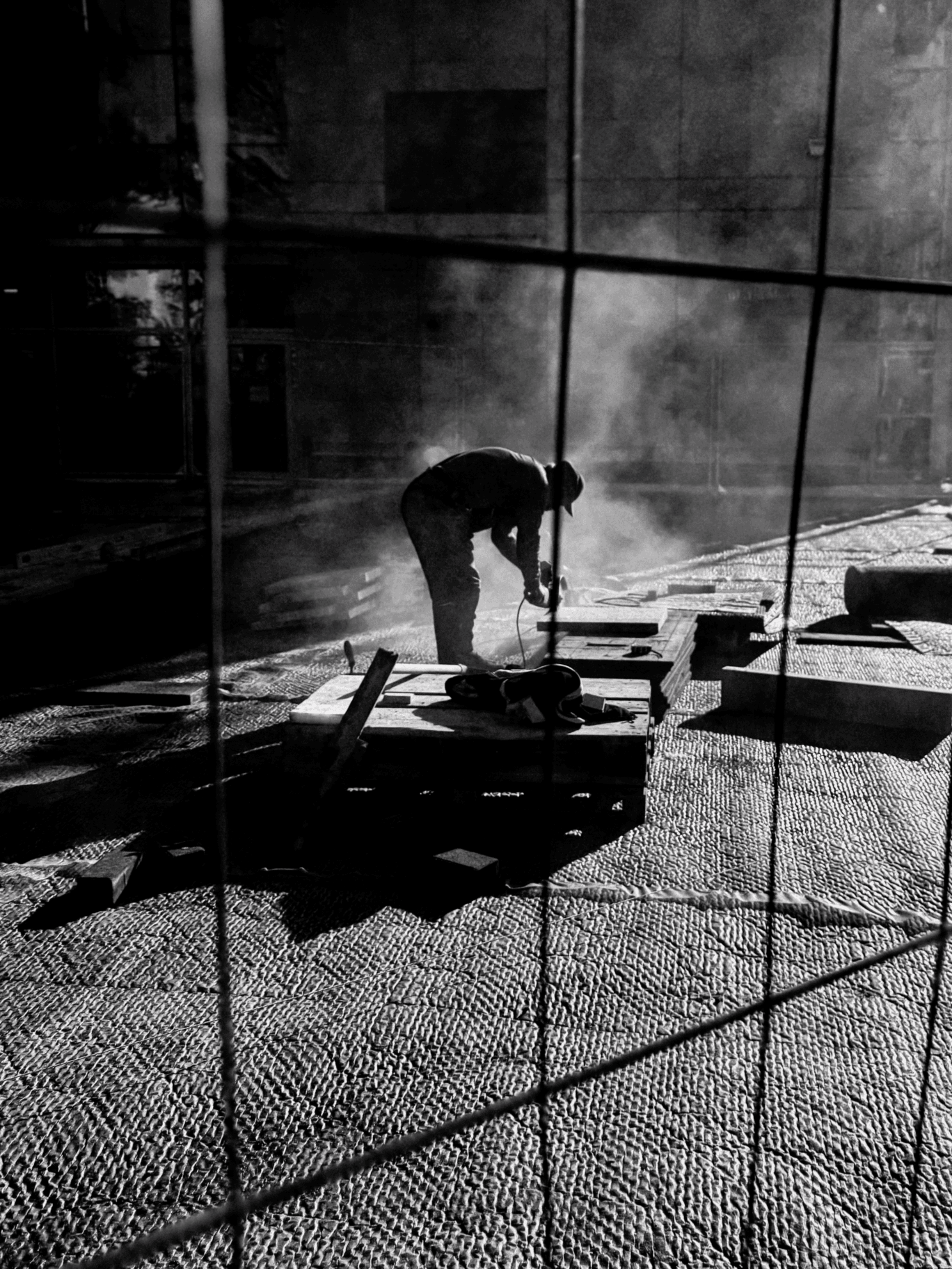 Person sitting on a ledge overlooking New York City skyline