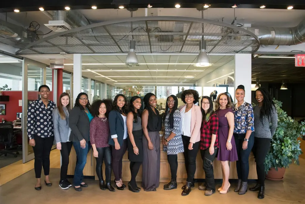 A group of smiling women standing next to each other