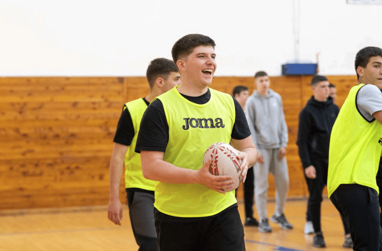 Young student with rugby ball