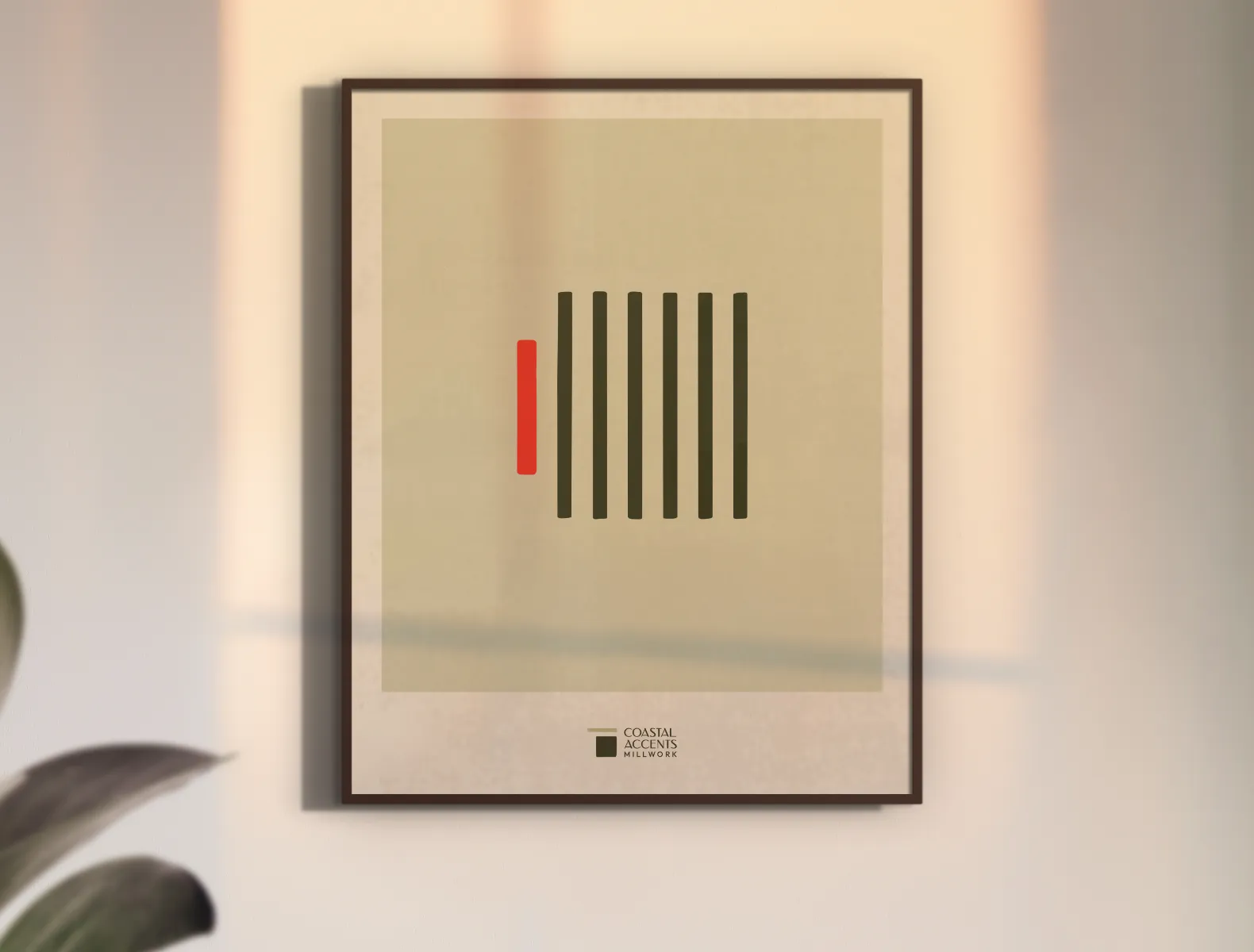 A joinery graphic element printed on a sage background framed in a black frame hanging on a cream wall.