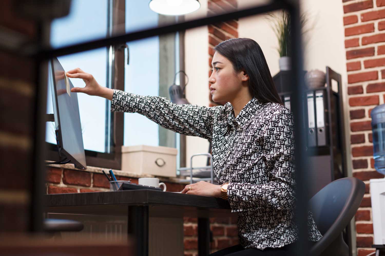 Profissional utilizando computador no escritório para acessar sistema e realizar tarefas de TI - FindUP - PMO