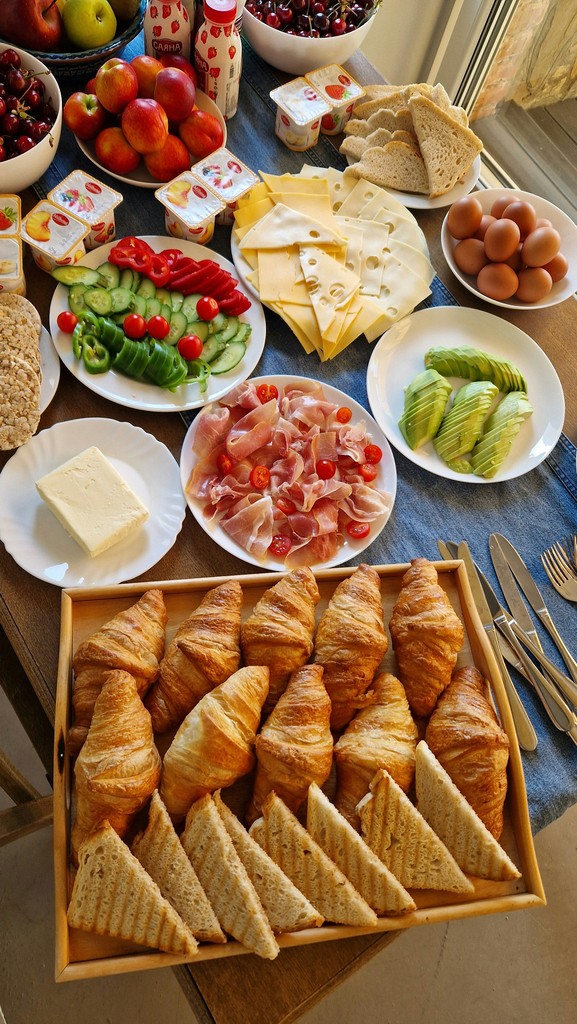 a table filled with plates of food and bowls of fruit