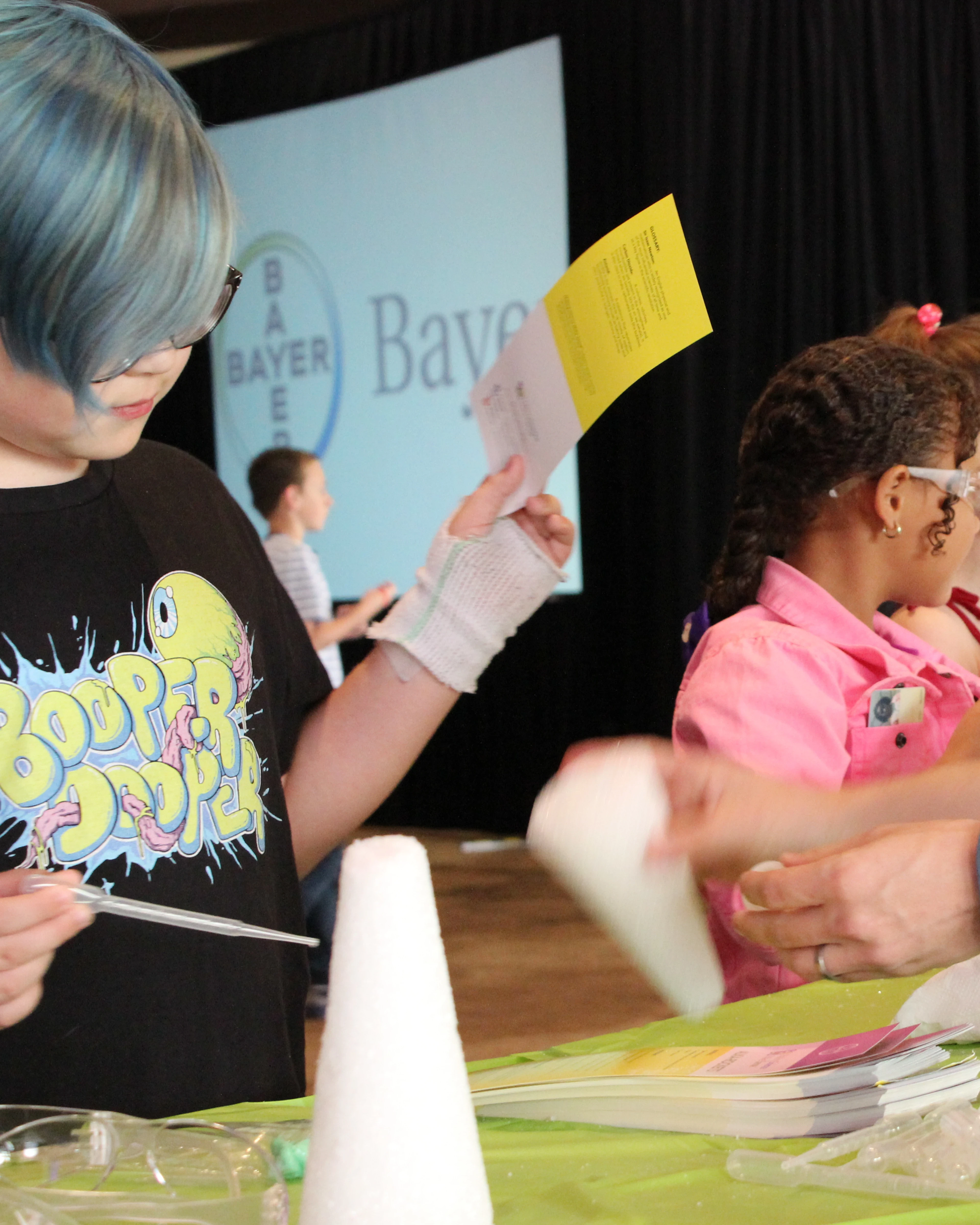 Children conduct an experiment at Bayer's breakfast symposium during HFA 2016