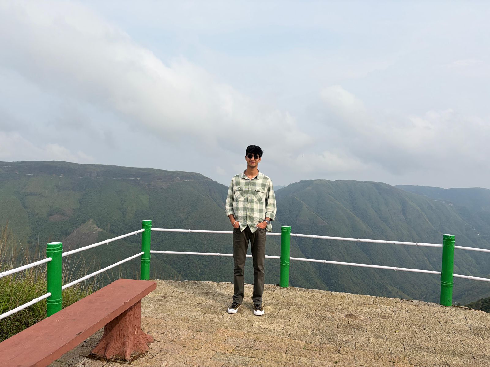 a couple of people standing on top of a mountain