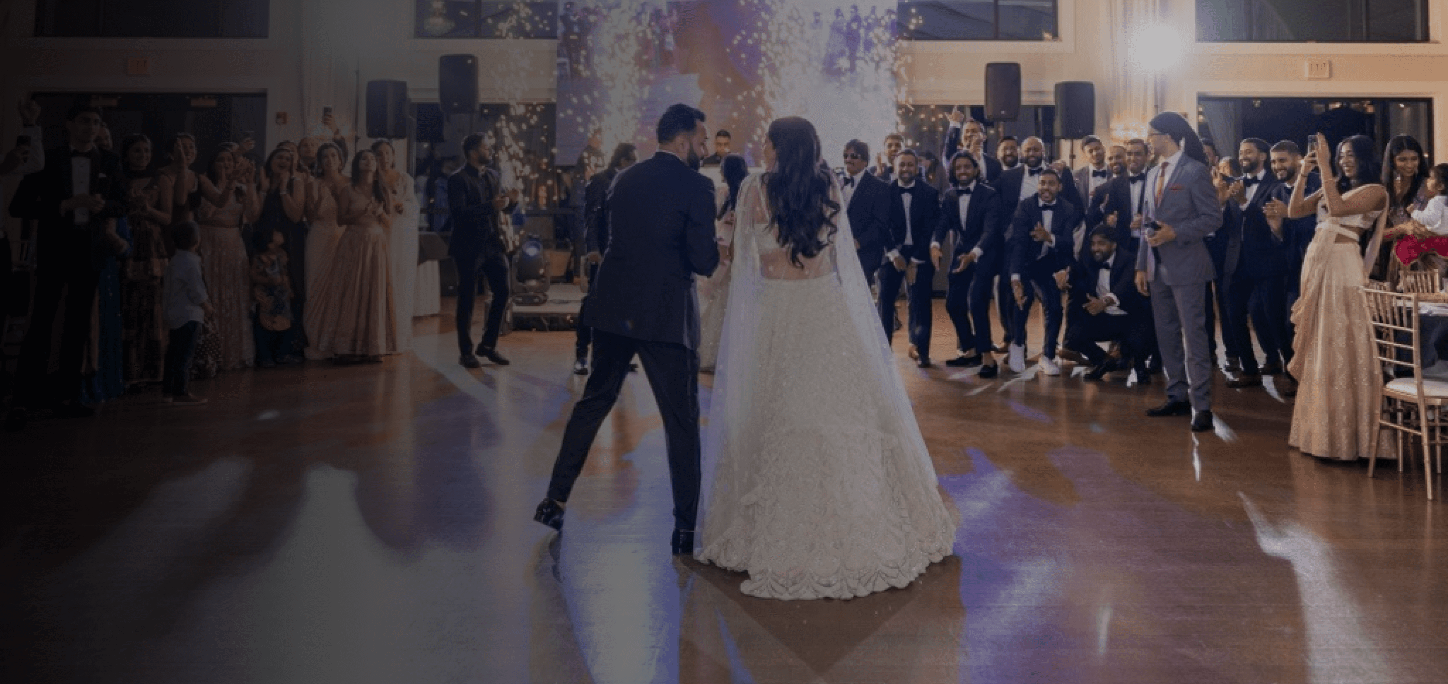 Couple holding hands walking down a corridor in traditional wedding attire