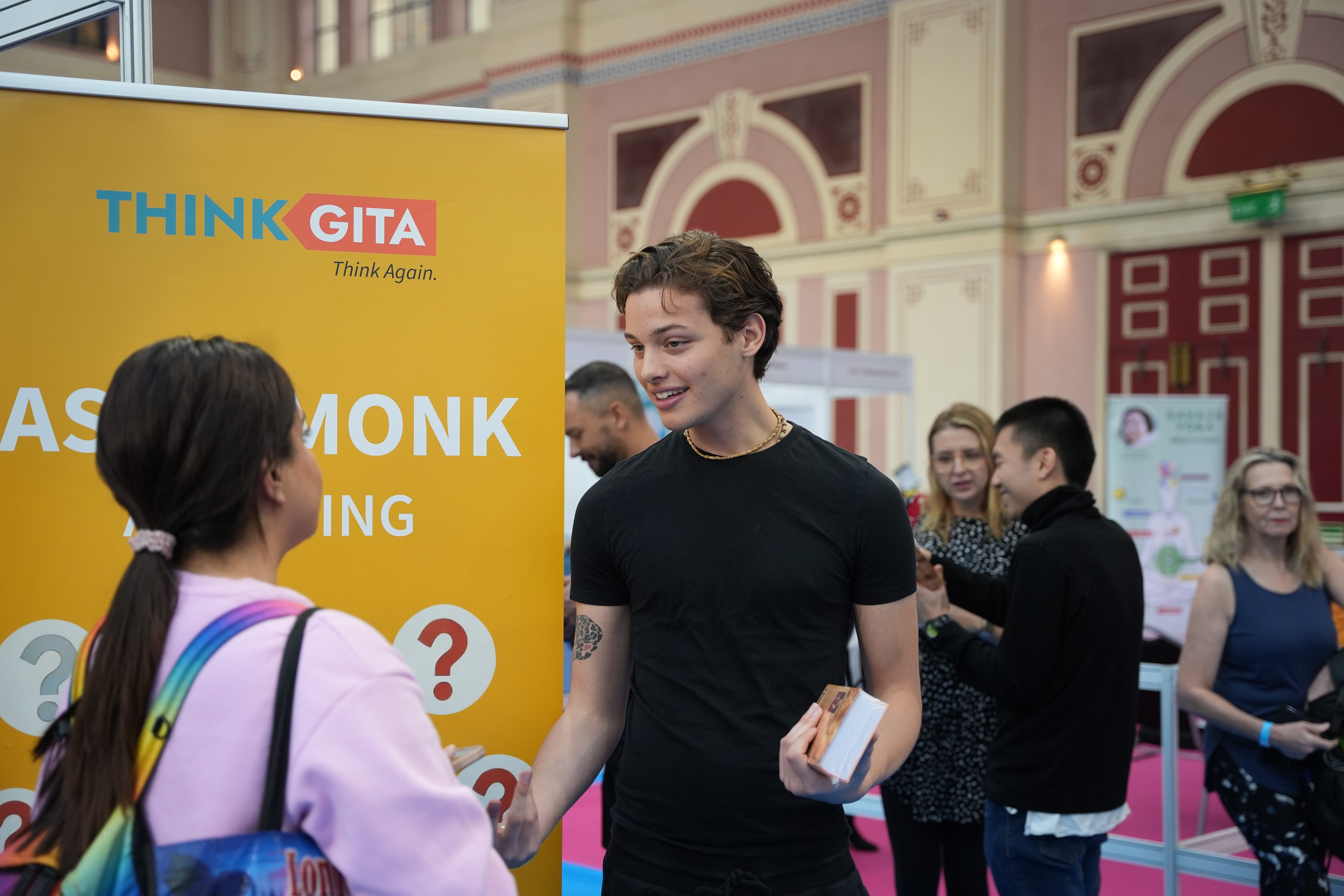 A man stading with Surfboard