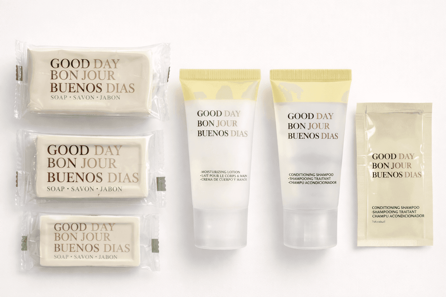 Good Safe Day amenity collection featuring bar soaps, shampoo, and lotion in individual packaging displayed on a marble countertop in a hotel-style bathroom setting