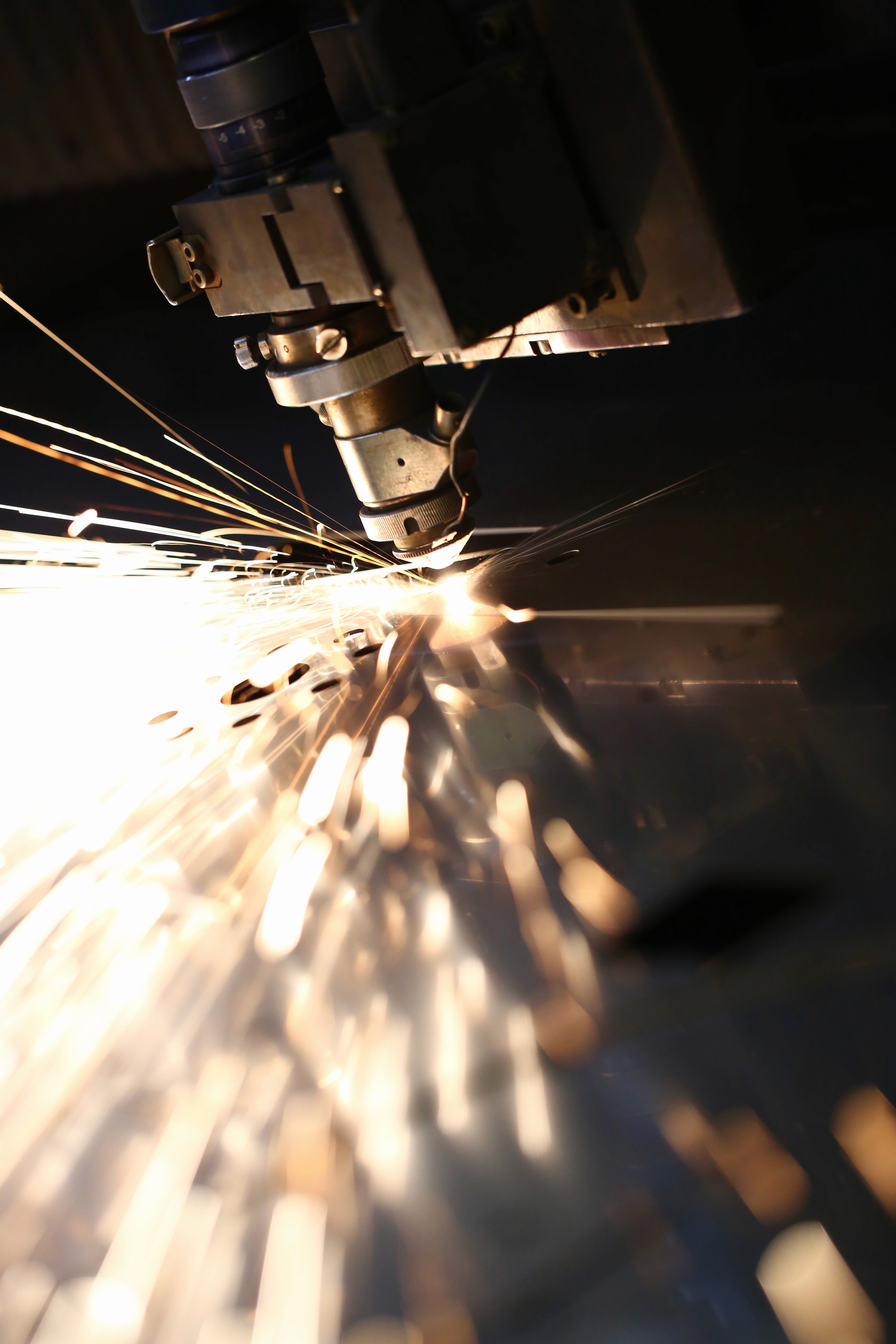 A worker in a hard hat inspects solar panels in a green field, using a tablet to monitor performance.