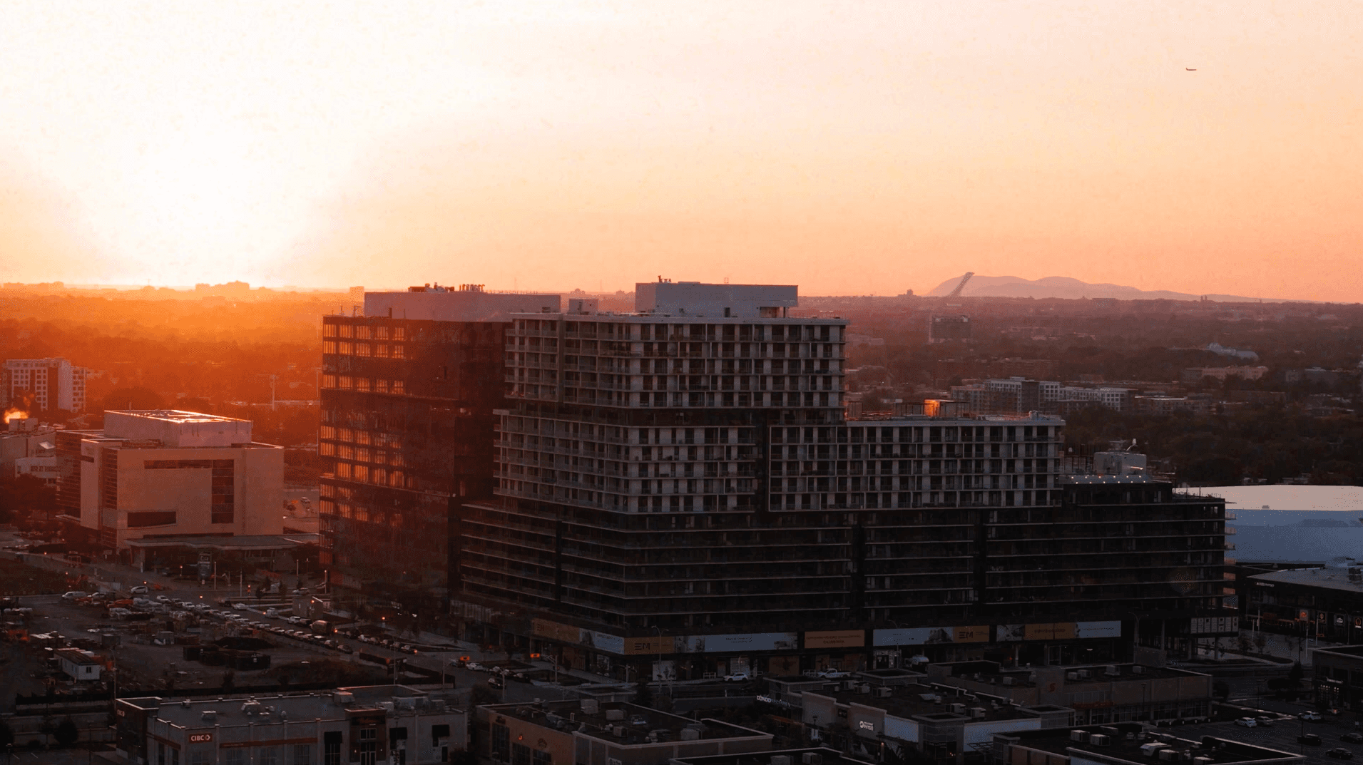 aerial view of a building in the city at sunset