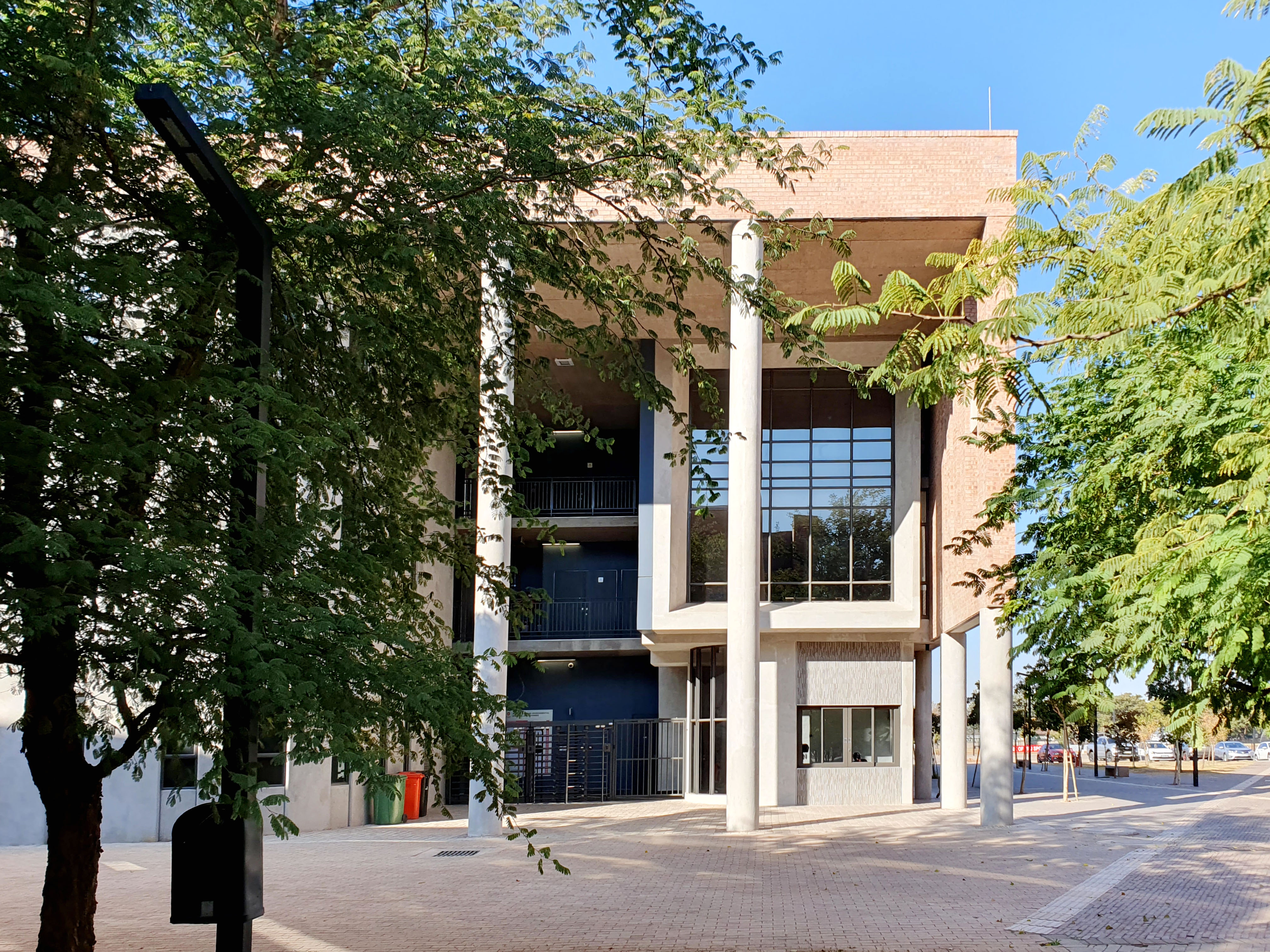 Close-up of black road bike with orange frame detail in low light.