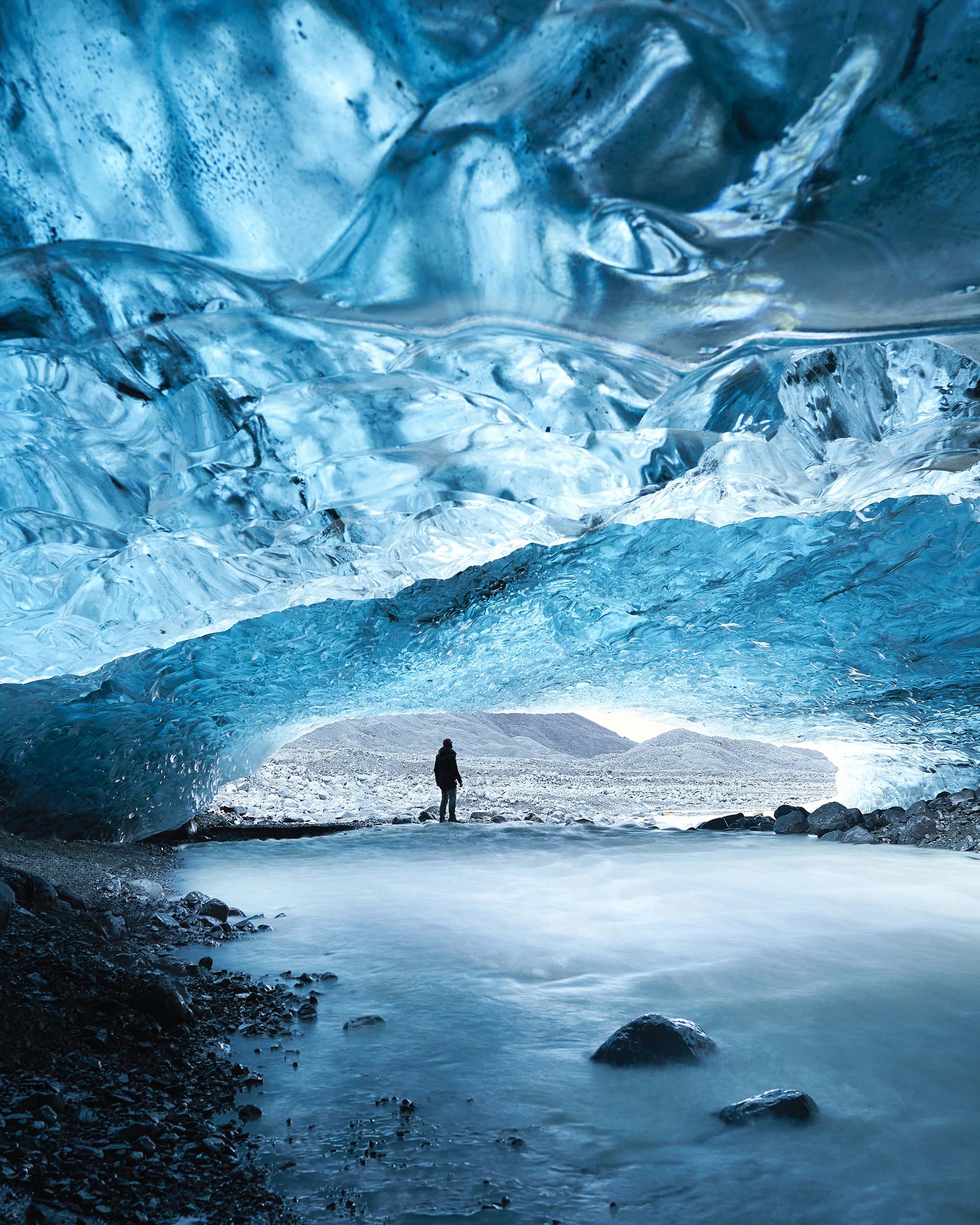Silhouette of person inside an ice cave