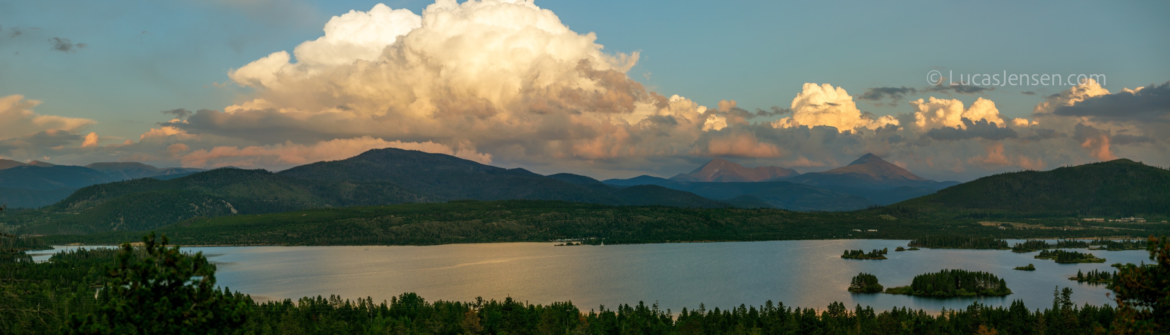 Panoramic landscape photograph of mountains, water, desert, or coast by Lucas Jensen