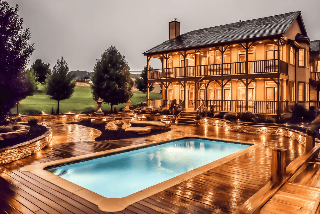 Red wooden harbor house overlooking boats, water, and snow-capped mountains.
