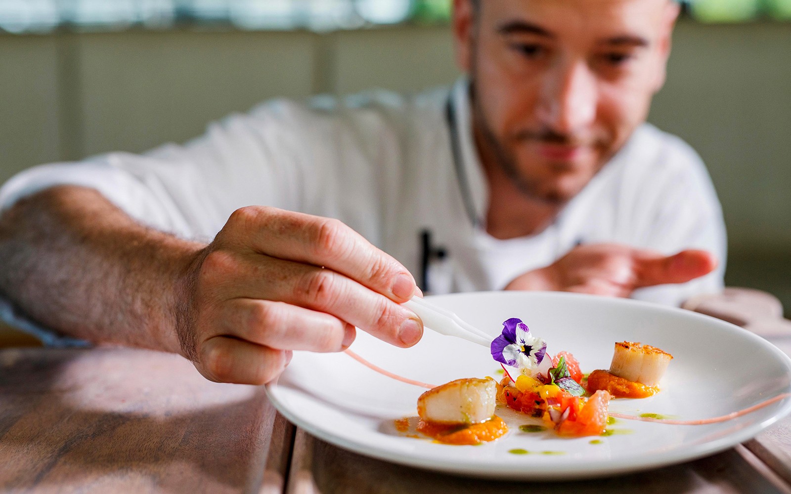 Chef garnishing a dish on the Vivid Sydney dinner cruise.